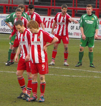 Tom Peers of Altricham in action with Claudio Ofosu of Hartlepool